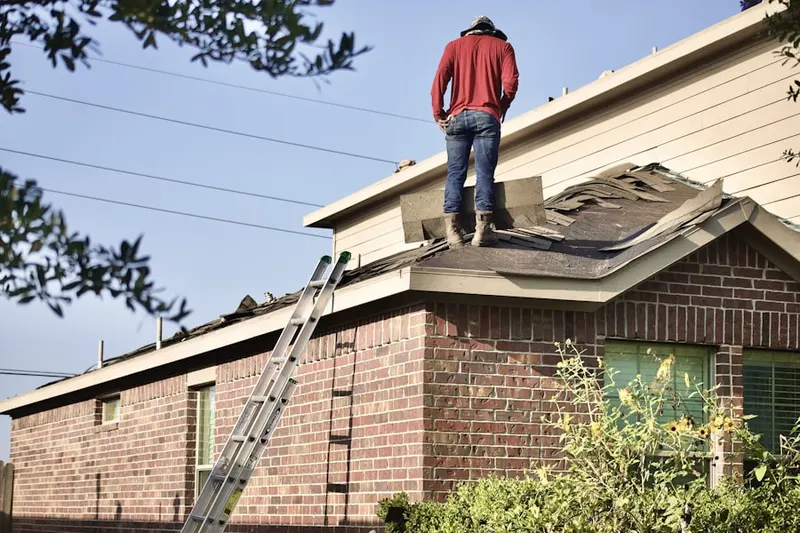 Professional roofer working on a residential roof in Belcoville